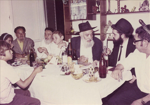 A gathering of neighbors and rabbis at the Malca family’s home in Musrara, on Shivtey Yisrael street.